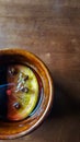 Background with brown ceramic mug with mulled wine with orange slice and carnation buds