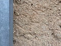 Background with brown color cement wall post and broken small pebbles Royalty Free Stock Photo