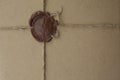 Background of brown package paper with a sealing wax stamp Royalty Free Stock Photo