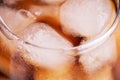 Background of brown soda, cold tea or coffee with ice cubes and bubbles, macro. Fresh cold sweet drink with ice Royalty Free Stock Photo