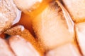 Background of brown soda, cold tea or coffee with ice cubes and bubbles, macro. Fresh cold sweet drink with ice Royalty Free Stock Photo
