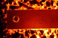 Background of burning coal anthracite and a red-hot steel strip with a hole. Royalty Free Stock Photo