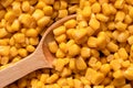 Background of canned sweet corn with wooden spoon. Top view Royalty Free Stock Photo