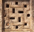 Background with carved swastika sign on Indian rock-cut architecture example. Window of 7th century Hindu temple