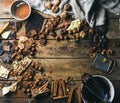Background with chocolate, nuts and spices over wooden backdrop Royalty Free Stock Photo