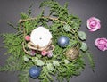 Background for Christmas and New Year. Green spruce branch with a Christmas ball on a black background. white candle with christma