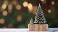 Background for Christmas with small cute Christmas Trees standing on wooden board with bokeh lights in background