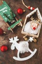 Background of Christmas toys, top view. Sleigh and moose rocking chair with red shiny balls