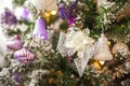 Background from a Christmas tree decorated in blue and purple close-up. Greeting card from a Christmas tree with purple decoration Royalty Free Stock Photo