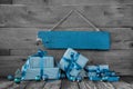 Background: Christmas voucher or coupon with presents in turquoise blue.