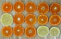 background with citrus slices of lemon and tangerine on a lined wooden surface
