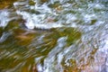 Background of clean water in fast river flow. Fast flow in mountain creek. Texture of the fast river natural water surface. Motion Royalty Free Stock Photo