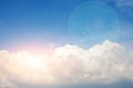 Background of the clear blue cerulean sky with big fluffy white cloud and bright sun beams with blick upon on it Royalty Free Stock Photo