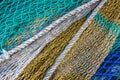 Background with close up of fishing nets, blue, green, yellow, white Royalty Free Stock Photo