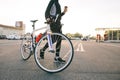 Background. Close-up of a highway bike, and a cyclist on the background of the sunset in a car park