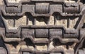 Background Close-up on a rusty old caterpillar tank worn on wheels standing on the road. Royalty Free Stock Photo