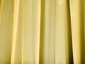 Yellow curtain as background. Backlight. Royalty Free Stock Photo