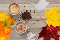 Background of coffee, cappuccino, sugar, milk, cookies on the table. Autumn, fall leaves.