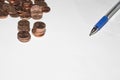 Background with coins and pen on top of a sheet of paper Royalty Free Stock Photo