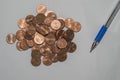 Background with coins and pen on top of a sheet of paper Royalty Free Stock Photo