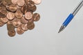 Background with coins and pen on top of a sheet of paper Royalty Free Stock Photo