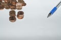 Background with coins and pen on top of a sheet of paper Royalty Free Stock Photo