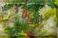 Background of color leaves of maple, fern, oak, seed and red berry in ice cube with air bubbles