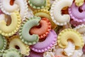 Background of colorful green, yellow, white, orange and pink italian crown pasta, close-up, top view