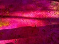 Background of colorful Holi powder in multiple colors lying scattered on the ground with the shadow of peoples.