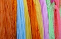 Background of many colorful pashmina scarves hanging