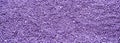 Background of colorful purple sprinkles. Food texture and pattern.