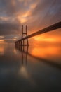 Background with colourful sunrise on the Lisbon bridge. The Vasco da Gama Bridge is a landmark, and one of the longest bridges in Royalty Free Stock Photo