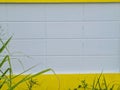 Background composition with yellow horizontal stripes displayed on a white painted plaster wall Royalty Free Stock Photo