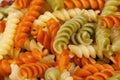 Background of cooked colored spiral pasta