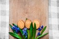 Background with cookies in the shape of Easter eggs on blue Scilla on a wooden cutting board Royalty Free Stock Photo