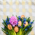 Background with cookies the shape of Easter eggs in the blue snowdrops on yellow kitchen towel Royalty Free Stock Photo