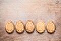 Background with cookies in the shape of Easter eggs with cookies on a wooden cutting board Royalty Free Stock Photo