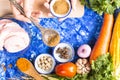 Background cooking or Woman cooking with ingredients spoon in her hands on background vegeteble on blue table.Dark tone and Top vi