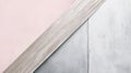 Background with copy space featuring a light wooden plank separating a pink surface and a gray concrete wall. The image Royalty Free Stock Photo