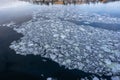 Background of cracked pieces of ice shards on the water. Ice floes floating on the river in the dark water Royalty Free Stock Photo