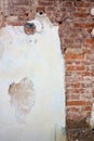 Background of cracked plaster covered shabby old brick wall, vertical rough abstract surface texture Royalty Free Stock Photo