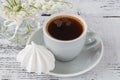 Background cup of espresso coffee spring lily of the valley bouquet