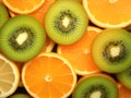 background of cut pieces of orange, lemon, kiwi photo