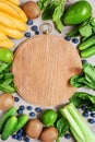 Background with cutting board, fresh healthy vegetables and fruits Royalty Free Stock Photo