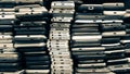 Background of damaged mobile phones. A bunch of broken smartphones. Used phones stacked on top of each other. Repair services and