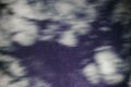 Background of dark-blue night sky with countless twinkle stars and moving white clouds upon on it Royalty Free Stock Photo