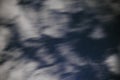 Background of dark-blue night sky with countless twinkle stars and moving white clouds upon on it Royalty Free Stock Photo