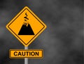 Background of dark grey sky with cumulus clouds and yellow road sign with text Danger Volcano. Bord the caution of a volcanic erup Royalty Free Stock Photo