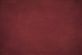 Background of dark red suede fabric closeup. Velvet matt texture of wine nubuck textile with gradient. Royalty Free Stock Photo