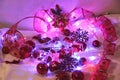 Christmas and Valentin background is decorated with lights of garlands, sparkling red balls, snowflake and decorative